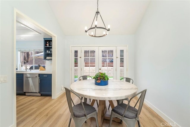 16 Allyssum, Rancho Santa Margarita, CA 92688 - dining area featuring a chandelier, light wood-style floors, vaulted ceiling, baseboards, and french doors