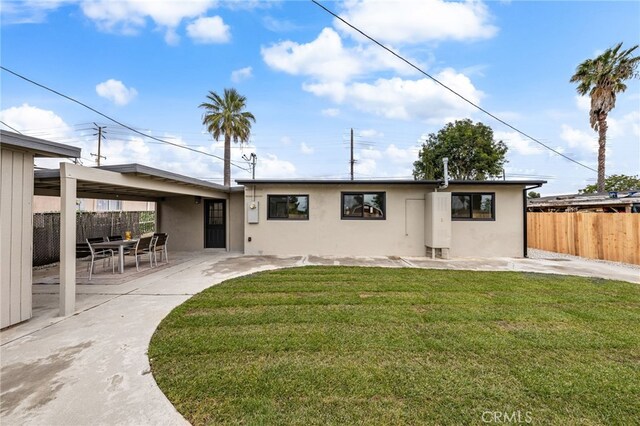 back of house featuring stucco siding and a patio