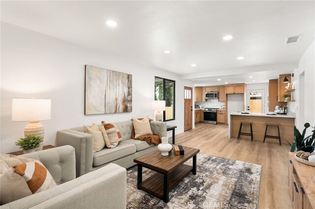 living room with recessed lighting and light wood-style floors