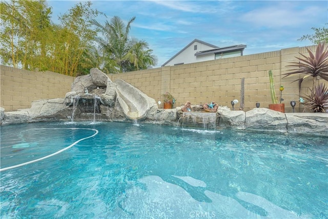 view of swimming pool with fence