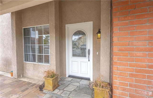 doorway to property with stucco siding