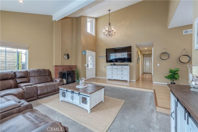 living room with a chandelier, a brick fireplace, high vaulted ceiling, baseboards, and beam ceiling