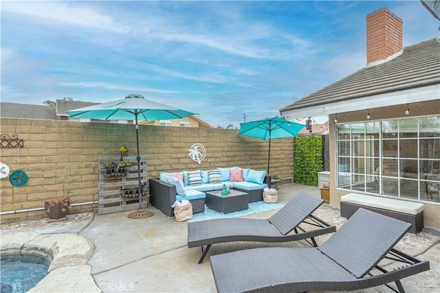 view of patio with an outdoor living space and fence