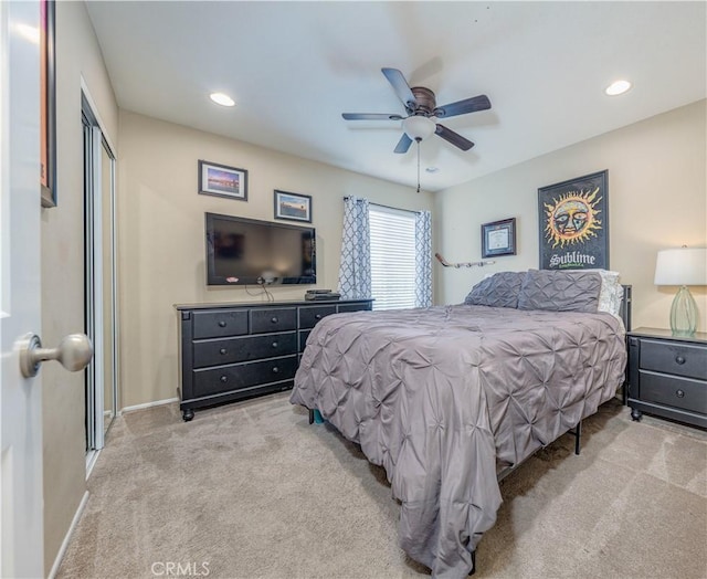 bedroom with light colored carpet, a closet, recessed lighting, ceiling fan, and baseboards