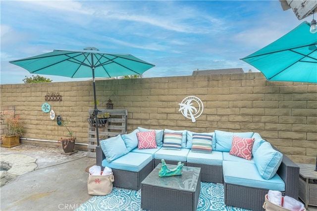 view of patio with an outdoor living space and fence