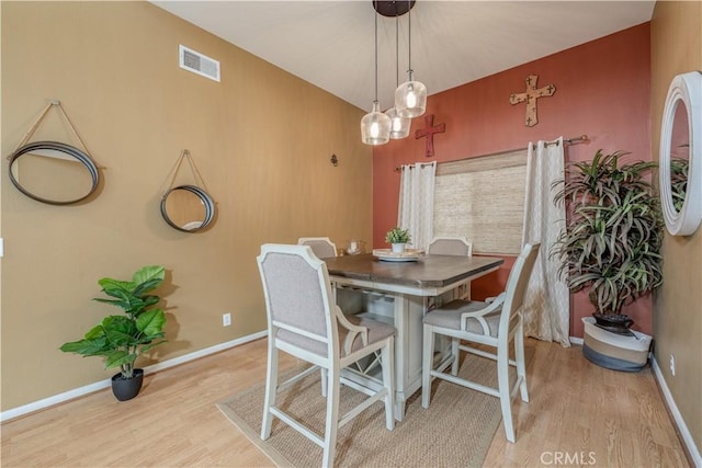 dining room featuring light wood-style floors and baseboards