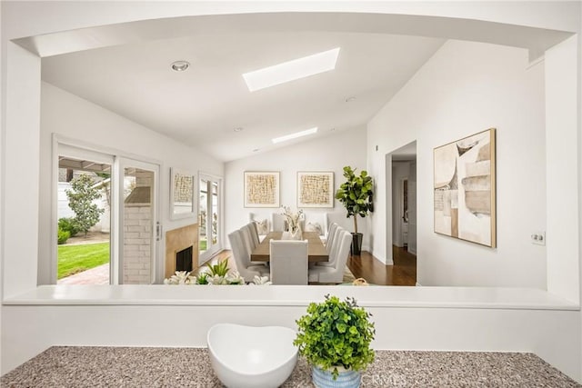 interior space featuring lofted ceiling and a skylight