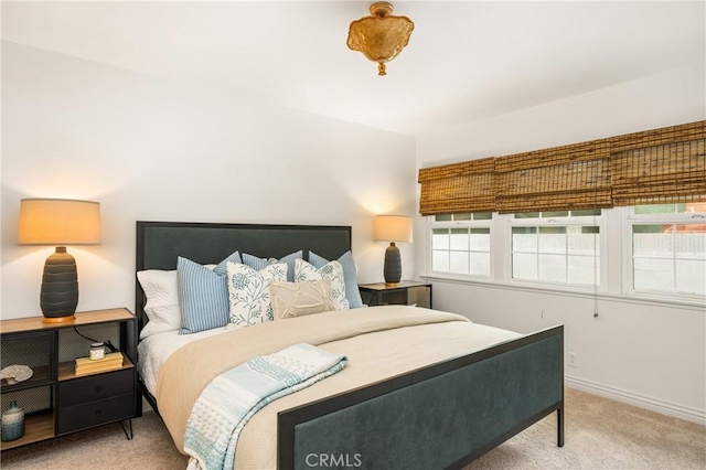 carpeted bedroom featuring baseboards