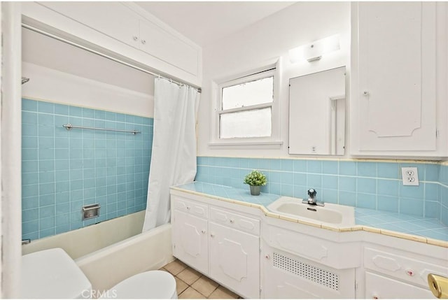 bathroom with toilet, tile patterned floors, decorative backsplash, shower / bath combo, and vanity