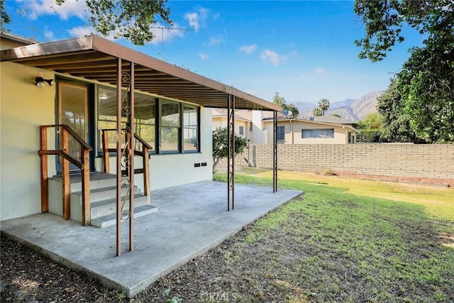 view of yard featuring a mountain view and a patio area