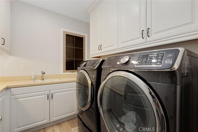 25 Tenderfoot, Irvine, CA 92602 - washroom with washer and dryer, cabinet space, and light wood-style floors