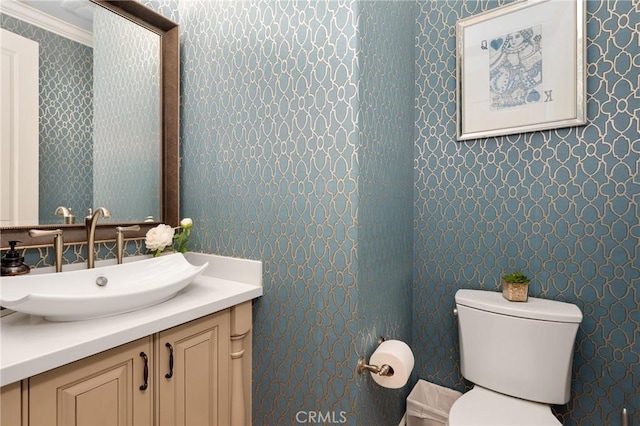 25 Tenderfoot, Irvine, CA 92602 - half bathroom featuring wallpapered walls, toilet, vanity, and ornamental molding