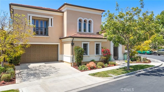 25 Tenderfoot, Irvine, CA 92602 - mediterranean / spanish home with a garage, driveway, stucco siding, and a tile roof