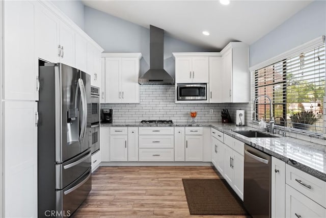 2247 Bella Ave, Upland, CA 91784 - kitchen featuring stainless steel appliances, wall chimney range hood, a sink, lofted ceiling, and white cabinetry