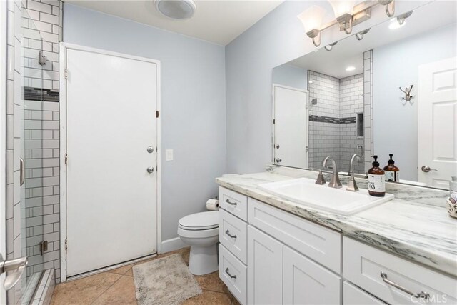 2247 Bella Ave, Upland, CA 91784 - full bathroom with a tile shower, toilet, vanity, and tile patterned floors