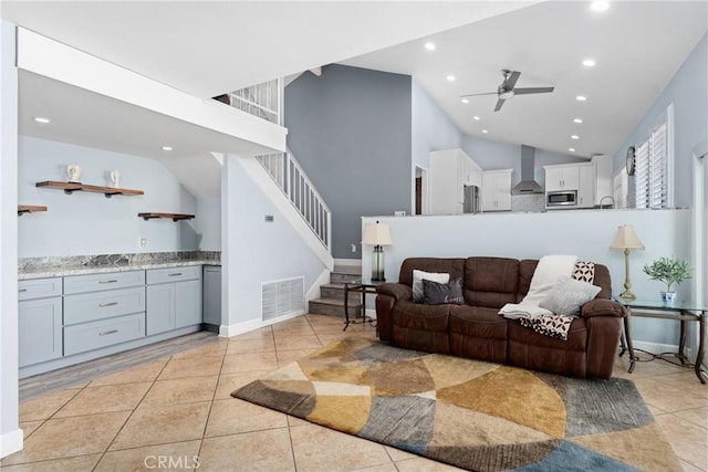 2247 Bella Ave, Upland, CA 91784 - living area with recessed lighting, light tile patterned flooring, stairs, ceiling fan, and high vaulted ceiling