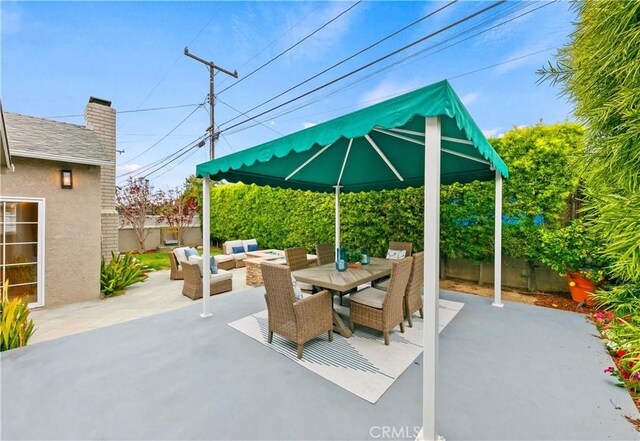 view of patio / terrace with outdoor lounge area, a fenced backyard, outdoor dining area, and a gazebo