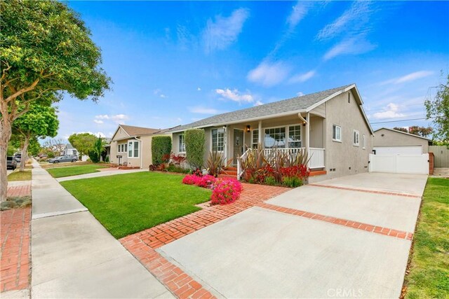 single story home with covered porch, a front lawn, an outbuilding, stucco siding, and a detached garage