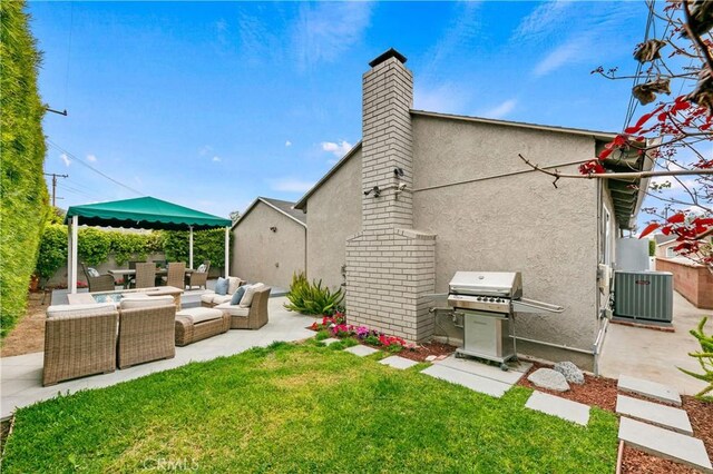 rear view of house featuring an outdoor living space, central AC, a patio area, stucco siding, and a lawn
