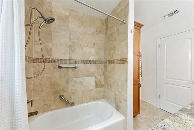 bathroom with shower / bath combination with curtain and tile patterned floors