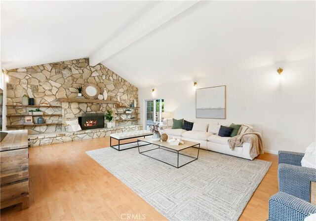 living area featuring wood finished floors, a fireplace, and baseboards