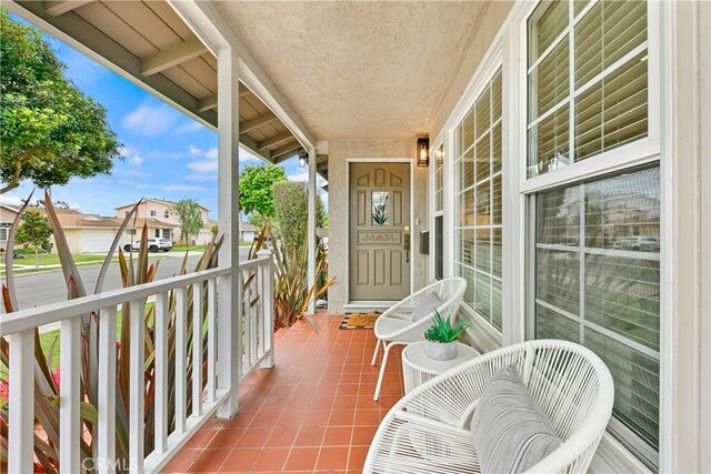 balcony featuring a porch and a residential view