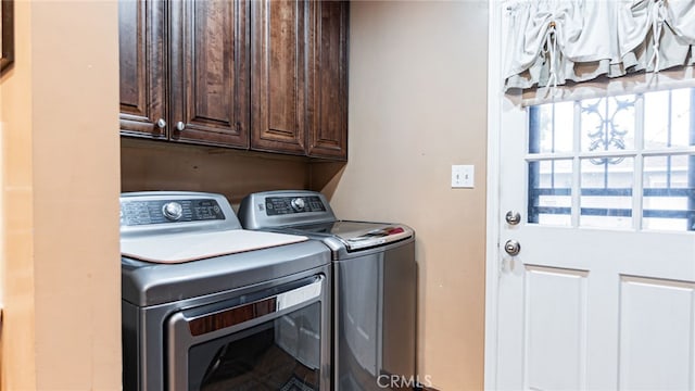 laundry room featuring cabinet space and separate washer and dryer