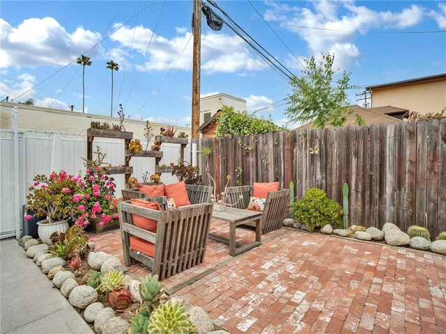 view of patio with a fenced backyard and an outdoor hangout area