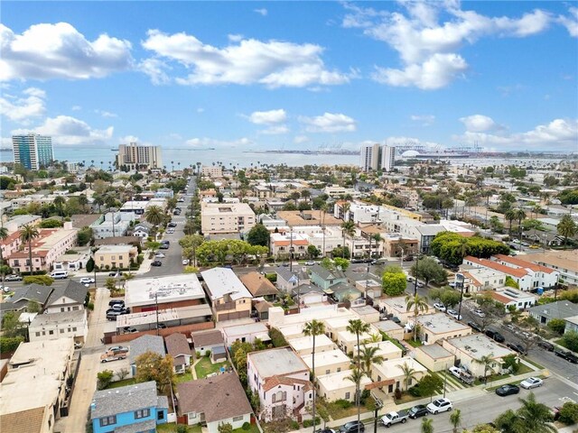 aerial view of property's location with nearby urban area and a large body of water