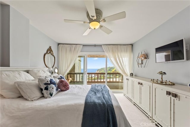 bedroom featuring access to exterior and a ceiling fan