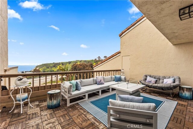 view of patio featuring outdoor lounge area and a water view