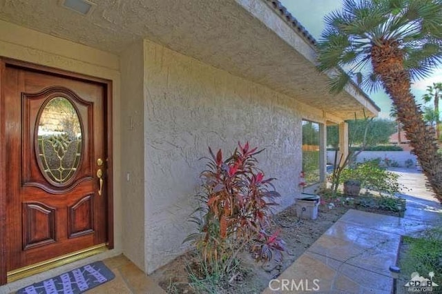 38730 Tandika Trl N, Palm Desert, CA 92211 - property entrance with stucco siding