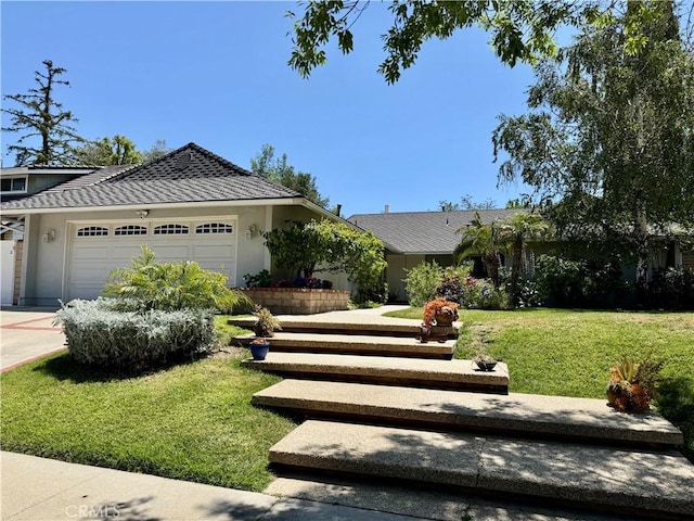 19020 Killoch Way, Porter Ranch, CA 91326 - view of front of house featuring an attached garage, a front lawn, stucco siding, and driveway