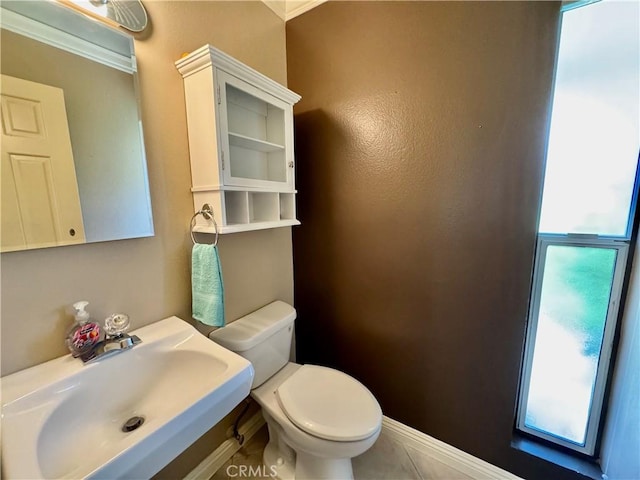 19020 Killoch Way, Porter Ranch, CA 91326 - half bathroom featuring a sink, healthy amount of natural light, toilet, baseboards, and crown molding