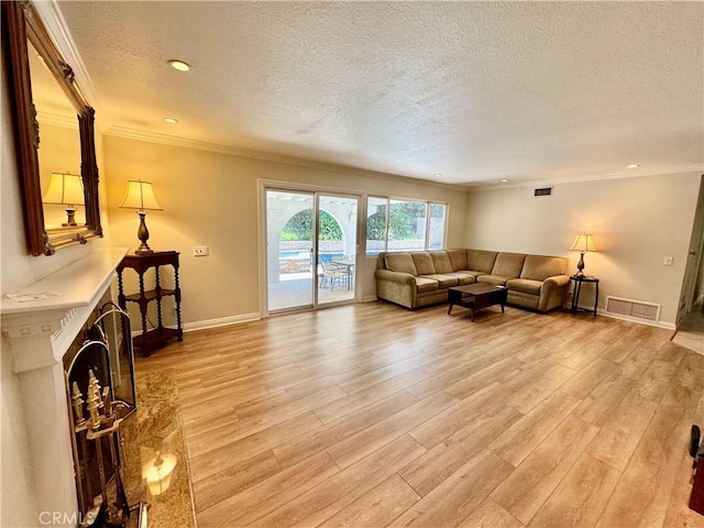 19020 Killoch Way, Porter Ranch, CA 91326 - living area featuring a textured ceiling, ornamental molding, light wood finished floors, baseboards, and recessed lighting
