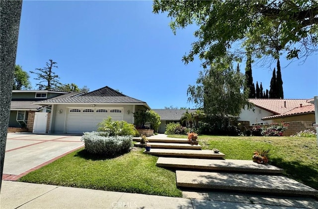19020 Killoch Way, Porter Ranch, CA 91326 - view of front of home featuring an attached garage, a front lawn, stucco siding, and driveway