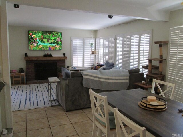 2640 Luciernaga St, Carlsbad, CA 92009 - living room featuring light tile patterned floors, beam ceiling, and a brick fireplace