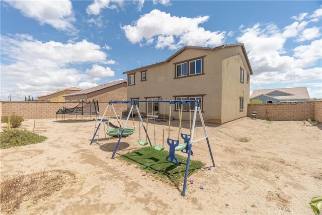 11952 Saxton Way, Victorville, CA 92392 - view of jungle gym featuring a trampoline and a fenced backyard