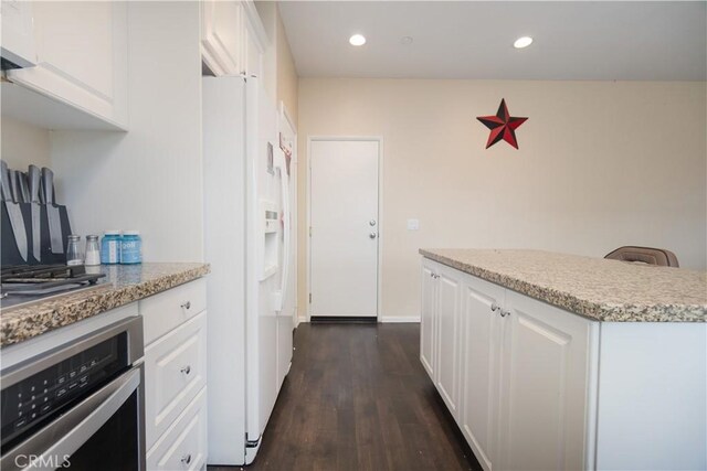 11952 Saxton Way, Victorville, CA 92392 - kitchen featuring white fridge with ice dispenser, oven, dark wood-type flooring, white cabinets, and recessed lighting