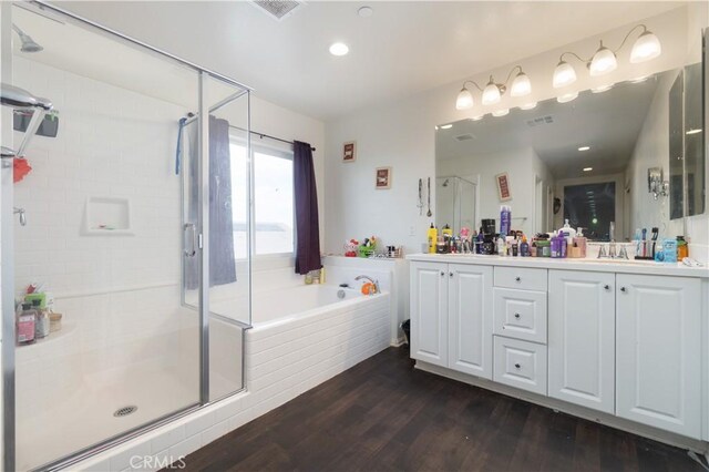 11952 Saxton Way, Victorville, CA 92392 - full bathroom featuring wood finished floors, a stall shower, double vanity, a bath, and recessed lighting