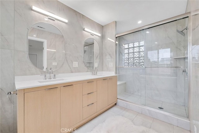 4531 N De Lay Ave, Covina, CA 91722 - bathroom with a marble finish shower, double vanity, tile patterned flooring, and tile walls