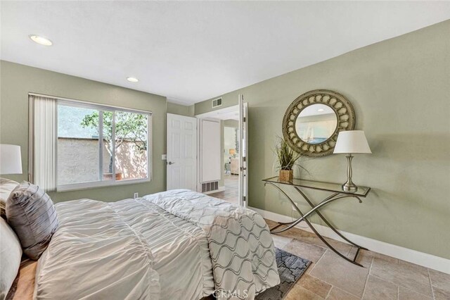 bedroom with baseboards, recessed lighting, and stone finish flooring