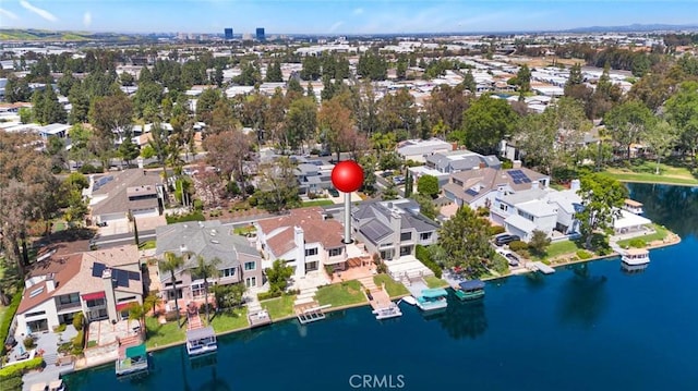 aerial view of property's location with a large body of water and nearby suburban area