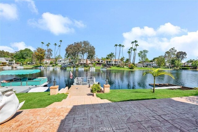 dock area with a water view and a lawn