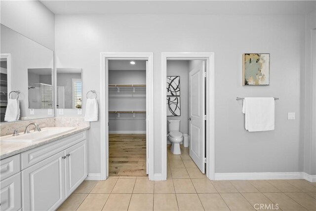 228 Wicker, Irvine, CA 92618 - full bathroom featuring vanity, baseboards, toilet, an enclosed shower, and tile patterned floors