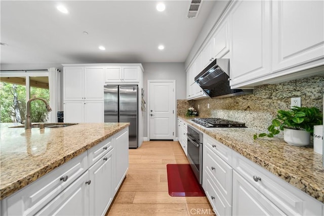 228 Wicker, Irvine, CA 92618 - kitchen featuring stainless steel appliances, a sink, light wood-style floors, white cabinetry, and recessed lighting