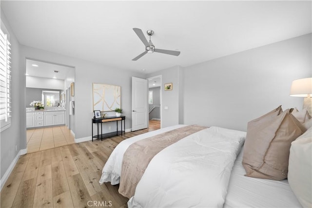 228 Wicker, Irvine, CA 92618 - bedroom featuring light wood-style flooring, baseboards, ensuite bath, and a ceiling fan