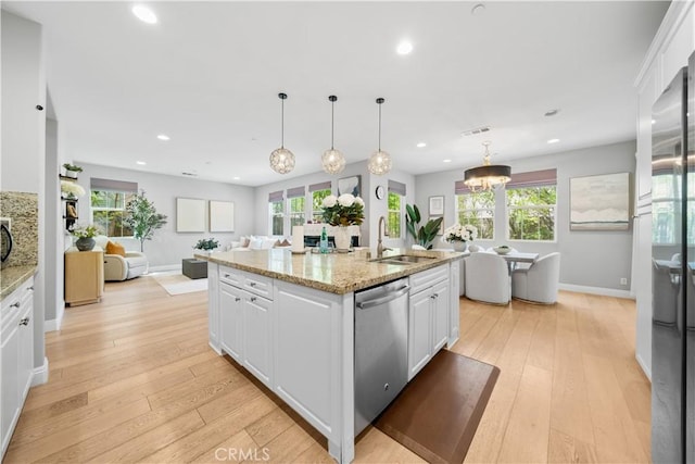 228 Wicker, Irvine, CA 92618 - kitchen with dishwasher, a sink, white cabinetry, open floor plan, and recessed lighting