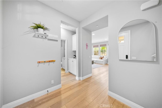 228 Wicker, Irvine, CA 92618 - hallway featuring light wood-type flooring, baseboards, recessed lighting, and a wall mounted air conditioner