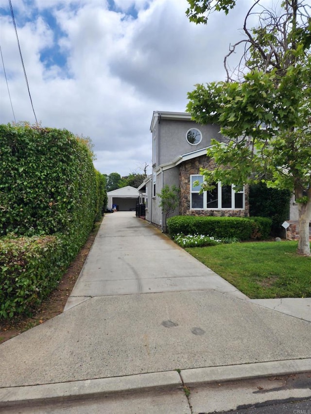4625 68th St, La Mesa, CA 91942 - view of property exterior with stone siding, a yard, and stucco siding